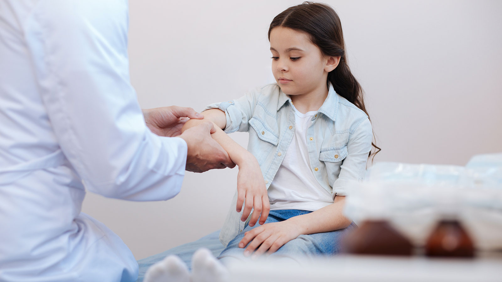 A child getting checked for an injury from a doctor.